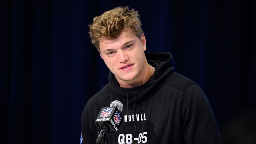 J.J. McCarthy at podium