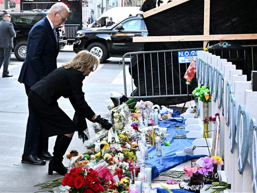 US President Joe Biden and First Lady Jill Biden lay flowers as they pay their respects to