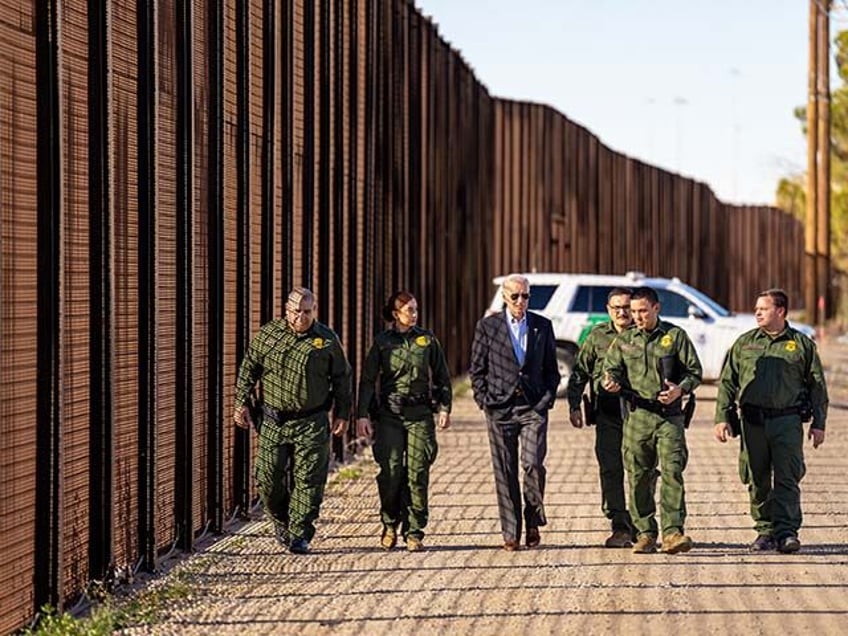 President Joe Biden walks with U.S. Border Patrol agents along a stretch of the U.S.-Mexic