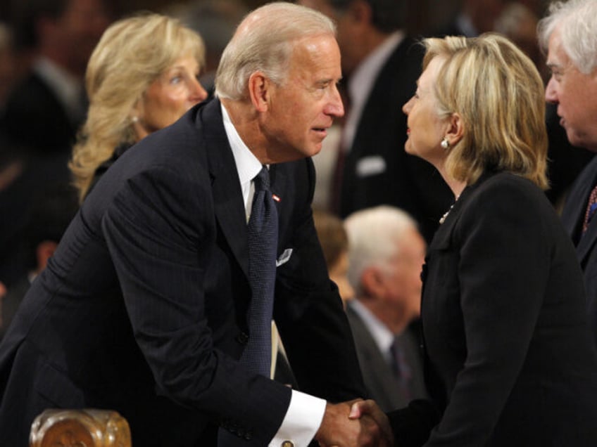 Vice President Joseph Biden (L) talks with Secretary of State Hillary Clinton as they await the start of the funeral services for US Senator Edward Kennedy at the Basilica of Our Lady of Perpetual Help in Boston, on August 29, 2009. Senator Kennedy died late on August 25, 2009 at …