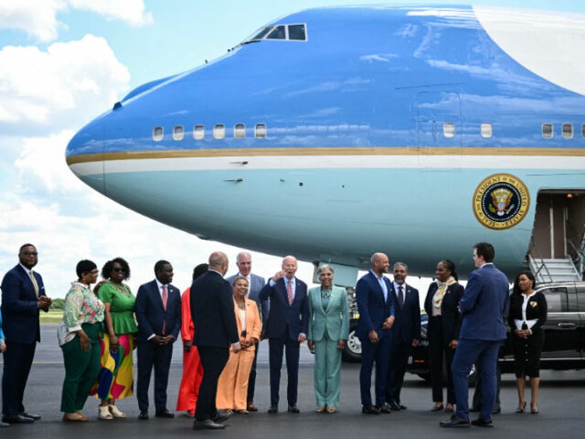 US President Joe Biden (C), standing next to US Representatives Barbara Lee (L), Democrat