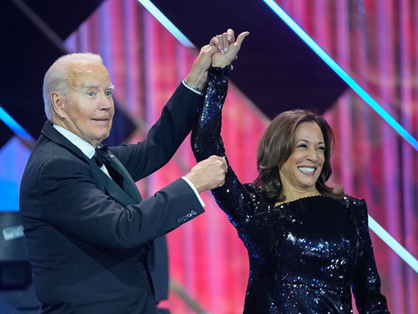 President Joe Biden, left, holds up the arm of Democratic presidential nominee Vice Presid