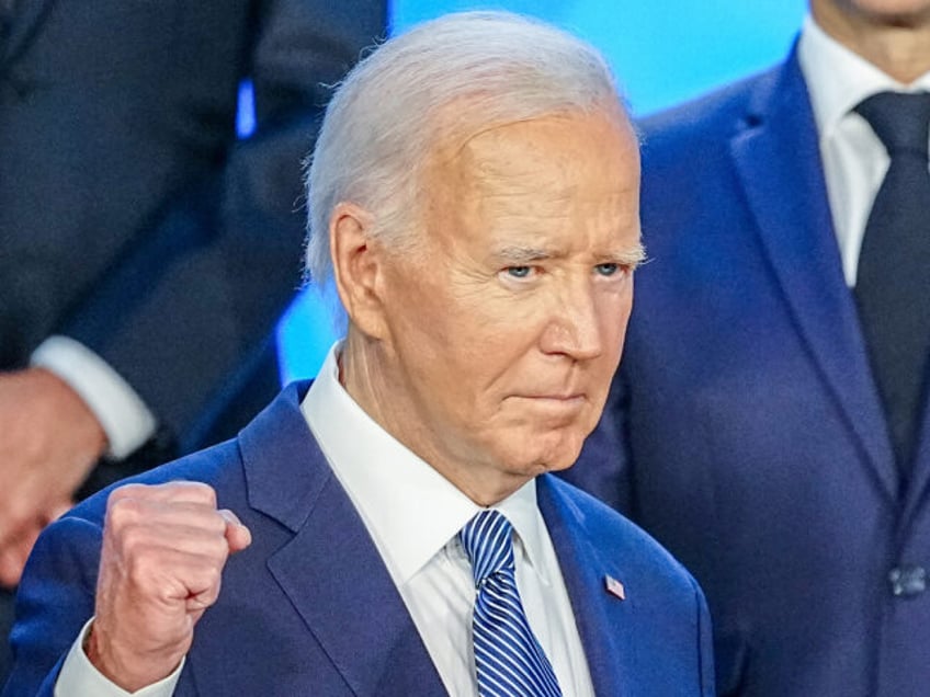 US President Joe Biden stands for a group photo with other heads of state at the NATO summ