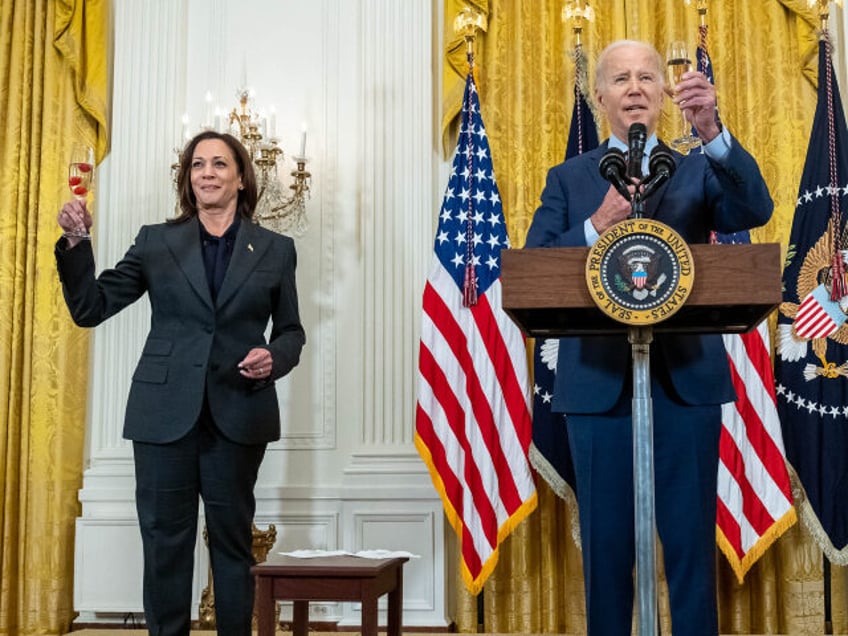 President Joe Biden and Vice President Kamala Harris raise their glasses in a toast at a r