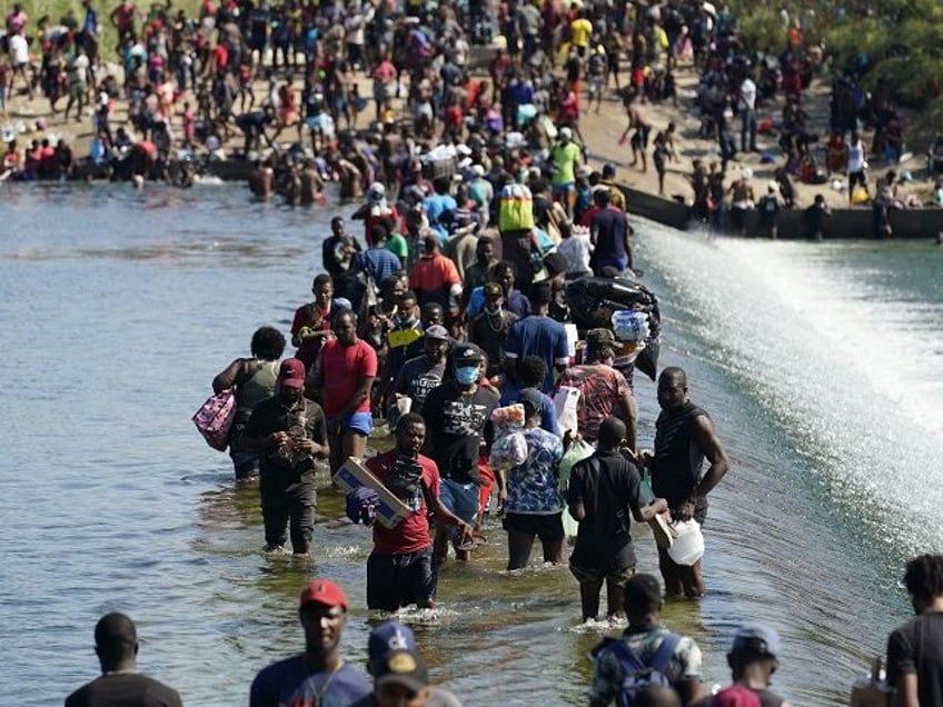 Haitian migrants use a dam to cross to and from the United States from Mexico, Friday, Sep