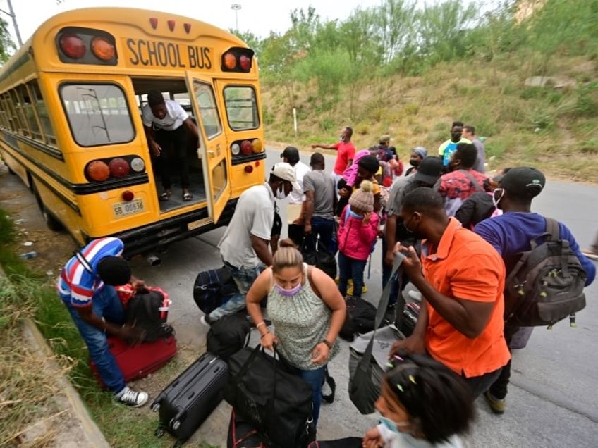 Mostly Haitian migrants prepare to board a bus taking them from a shelter to a US port of entry to start legal paperwork in Reynosa, Tamaulipas state, Mexico, in the border with McAllen, Texas state, US, on May 19, 2022. - A health rule imposed at the start of the Covid-19 pandemic that has blocked most asylum seekers at the US border with Mexico must stay in place, a judge ruled on May 20, 2022. (Photo by PEDRO PARDO / AFP) (Photo by PEDRO PARDO/AFP via Getty Images)