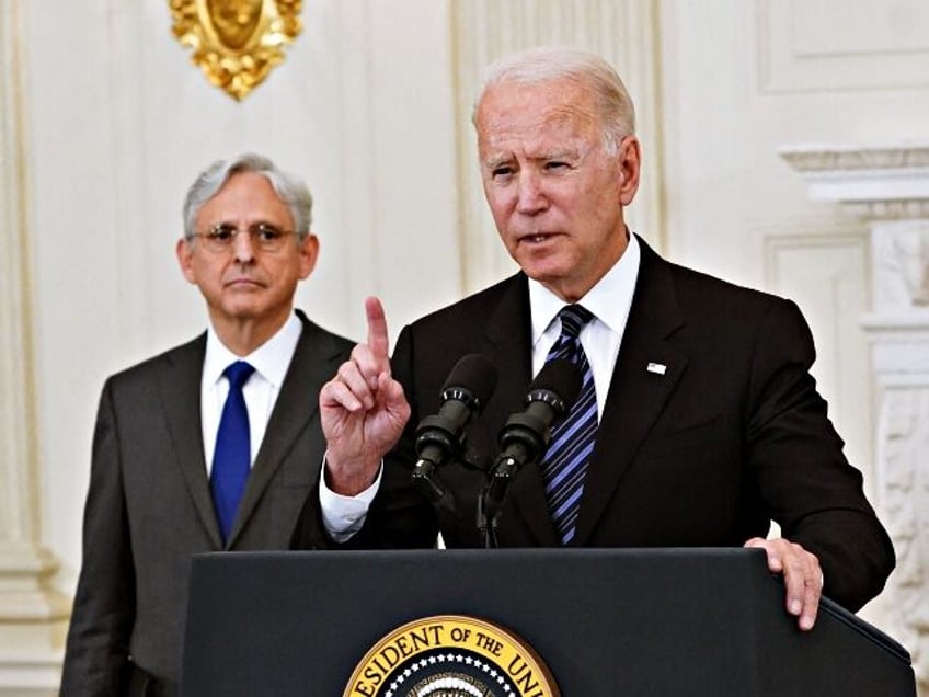 Attorney General Merrick Garland looks on as US President Joe Biden speaks about crime prevention, in the State Dining Room of the White House in Washington, DC on June 23, 2021. - President Biden unveiled new measures Wednesday to tackle gun violence against a backdrop of surging crime that his …