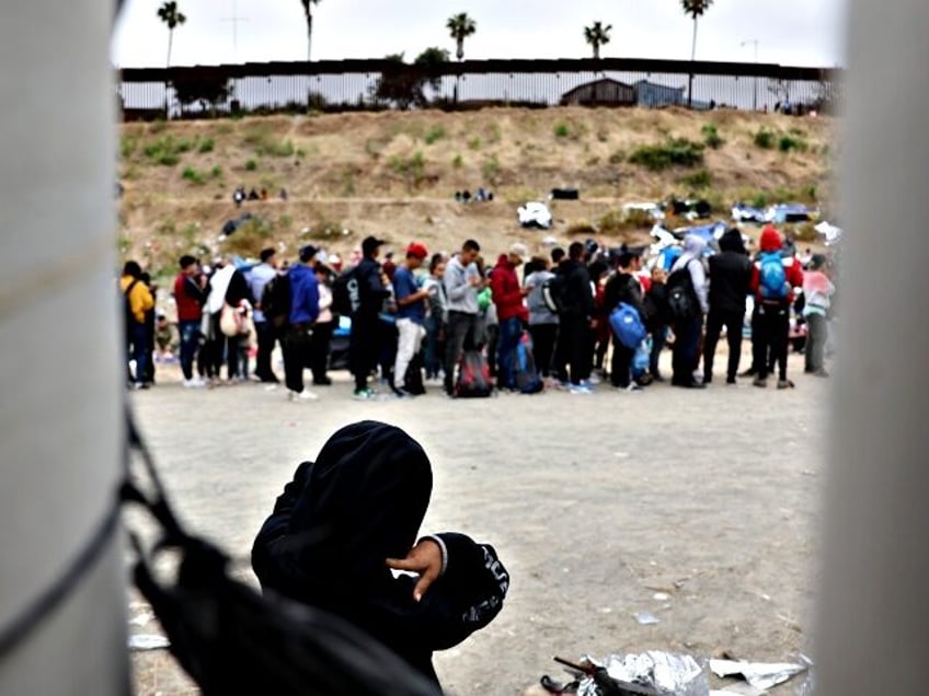 SAN DIEGO, CALIFORNIA - MAY 12: Immigrants who are seeking asylum in the U.S gather at a makeshift camp between border walls between the U.S. and Mexico on May 12, 2023 in San Diego, California. Some of the hundreds of migrants at the open air camp have been waiting for …