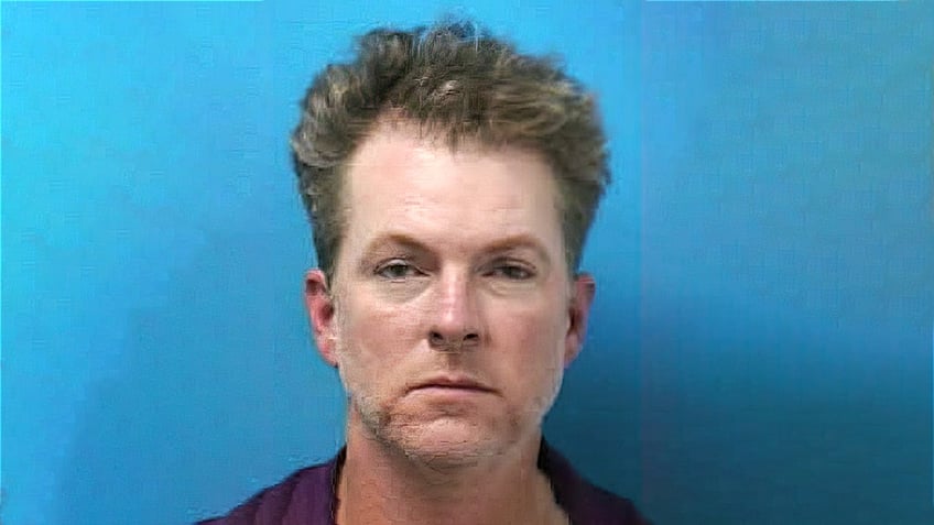 Mugshot of Joe Don Rooney of Rascal Flatts against a bright blue backdrop