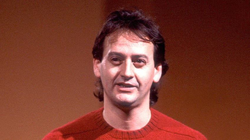 Comedian Joe Flaherty wears red shirt.