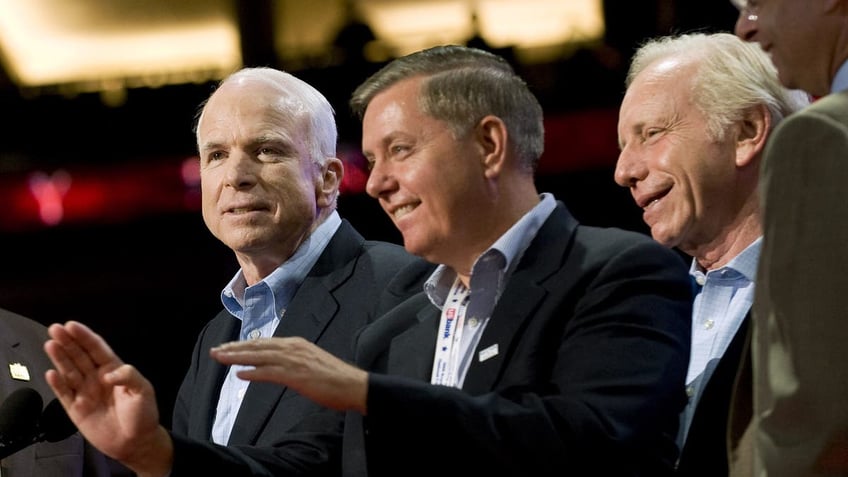 Senator John McCain of Arizona, Republican presidential candidate, left, speaks to Lindsey Graham, a Republican senator from South Carolina, center, and Joseph Lieberman, an independent senator from Connecticut, during a tour on day four of the Republican National Convention (RNC) at the Xcel Energy Center in St. Paul, Minnesota, U.S., on Thursday, Sept. 4, 2008. (Photo by Keith Bedford/Bloomberg via Getty Images)