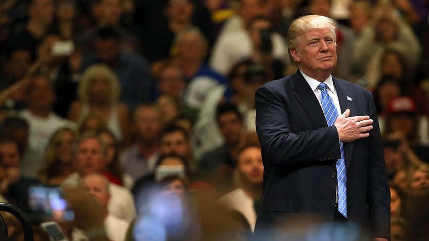 Donald Trump giving the Pledge of Allegiance in front of a crowd