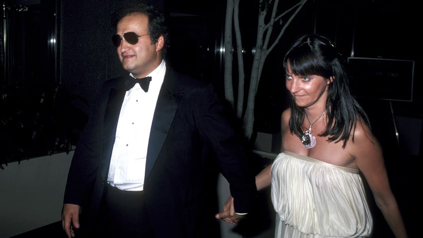 John Belushi walking with Judy Belushi