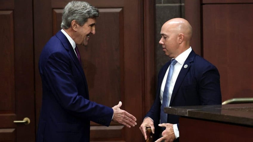 John Kerry (L) and Rep. Brian Mast (R-FL) (R)