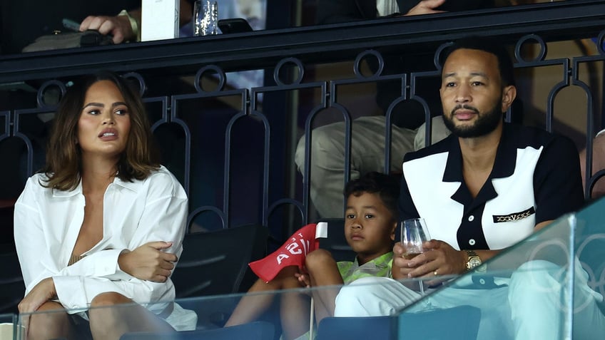 Chrissy Teigen and John Legend at an event in Paris