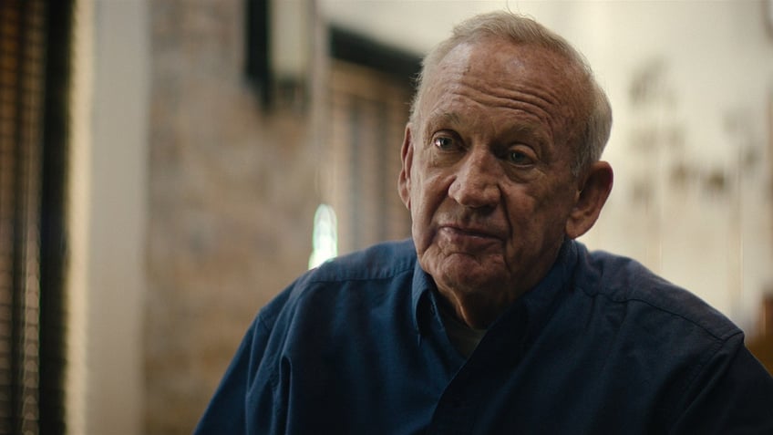 A close-up of John Ramsey in a blue shirt.