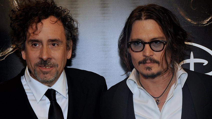 Director Tim Burton and Johnny Depp walk red carpet