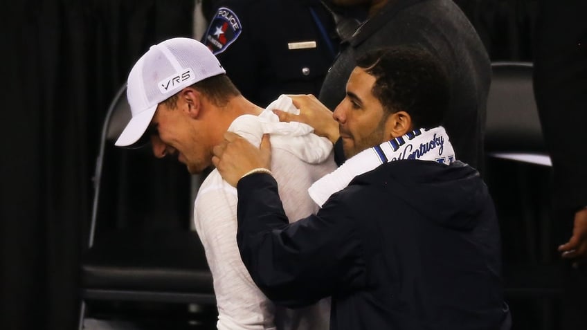 Drake greets football player Johnny Manziel