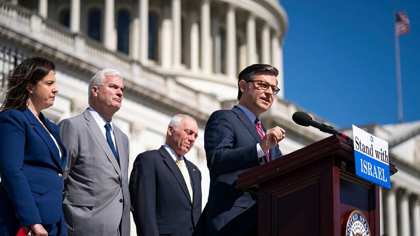 Mike Johnson speaks at a Stand with Israel podium