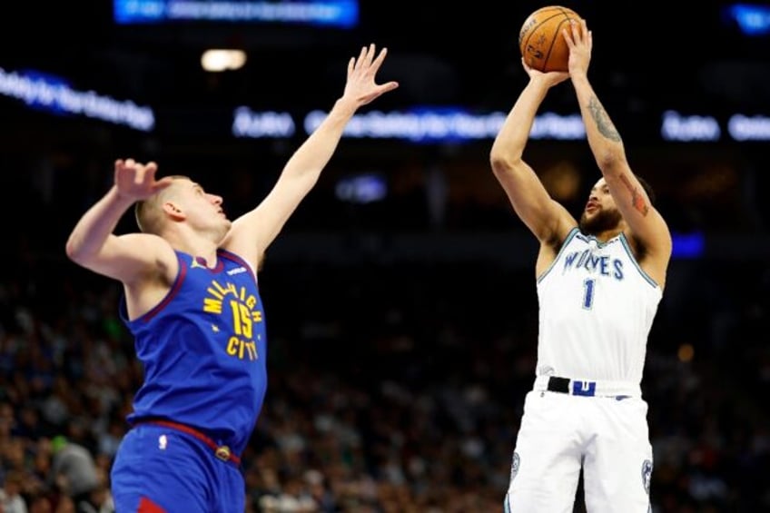 Denver's Nikola Jokic (left) defends as Minnesota's Kyle Anderson shoots in their Western