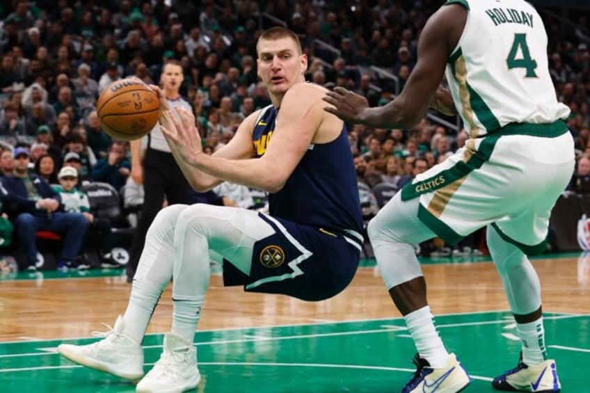 Nikola Jokic (L) scored 34 points as the Denver Nuggets ended Boston's 20-game unbeaten home record in the NBA on January 19, 2024