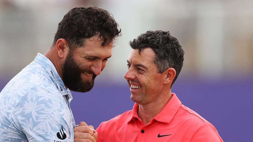 Jon Rahm and Rory McIlroy laugh