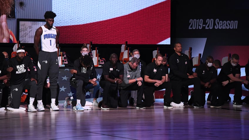 Jonathan Isaac stands for the anthem