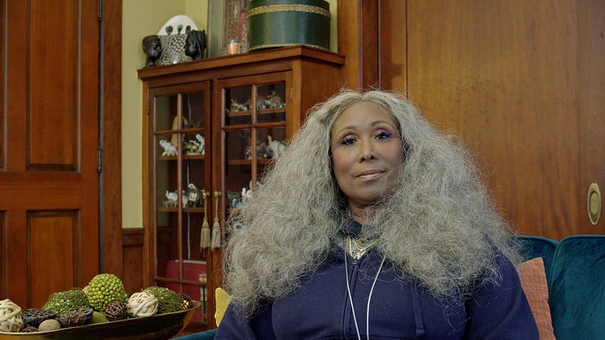 Yulanda Williams wearing a blue dress and silver jewelry.