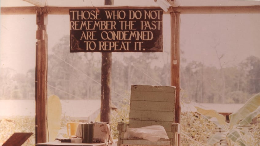 A Biblical sign on top of an empty chair.