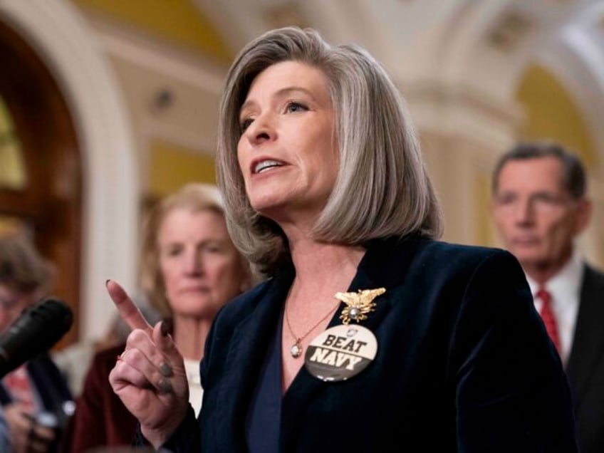 Sen. Joni Ernst, R-Iowa, wears a "Beat Navy" pin during a press conference after