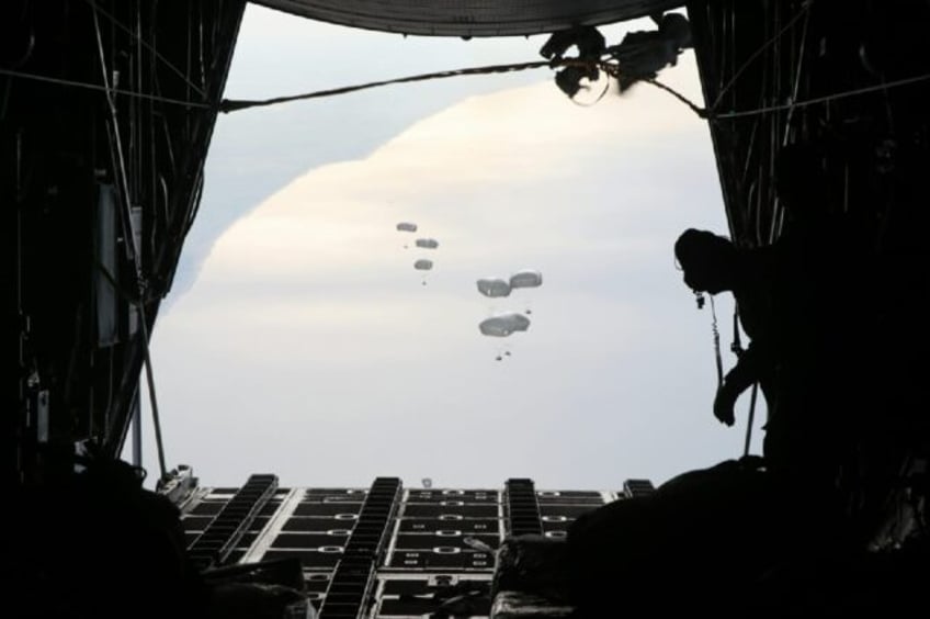 A Jordanian military aircraft drops humanitarian aid over the southern Gaza Strip