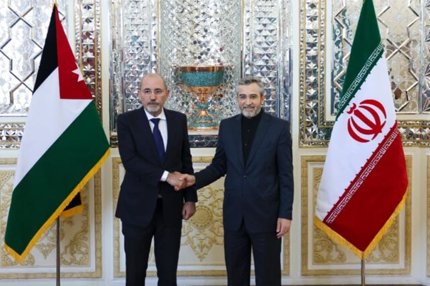 Iran's acting foreign minister Ali Bagheri (L) welcomes his Jordanian counterpart Ayman Sa