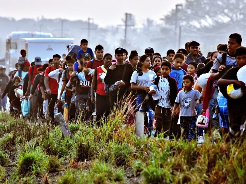 Migrants take part in a caravan towards the border with the United States in Arriaga community, Chiapas State, Mexico, on January 8, 2024. More than a thousand migrants of different nationalities have resumed their passage in the caravan after not receiving a favorable response to their demands to receive humanitarian …