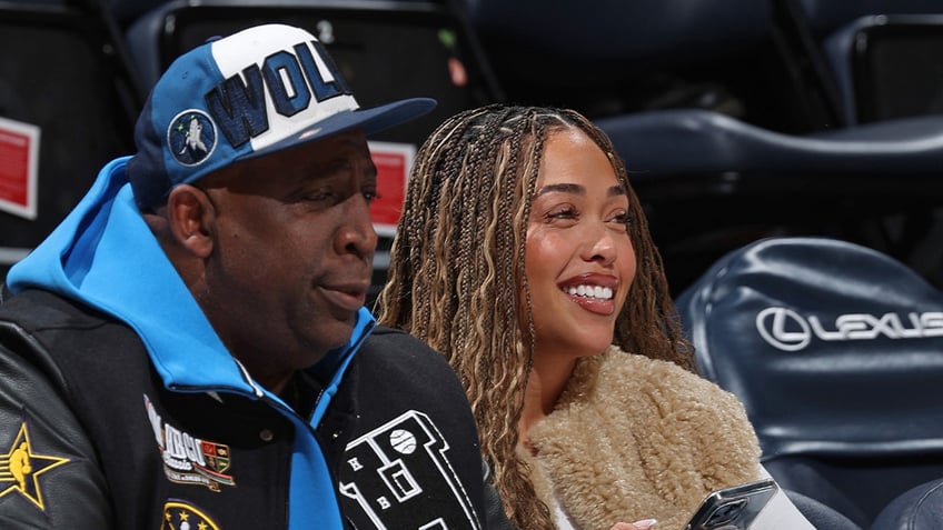 Karl Towns Sr. and Jordyn Woods sit courtside