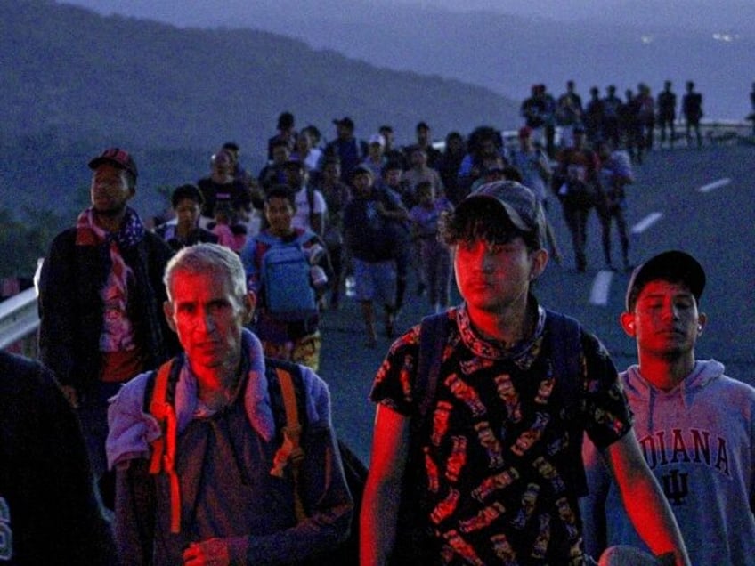 HUIXTLA, MEXICO - DECEMBER 3: Migrants advance during the early morning hours en route to