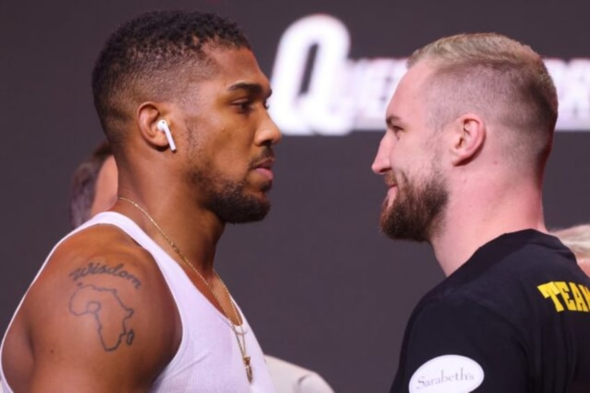 Britain's Anthony Joshua (L) and Sweden's Otto Wallin face off during a weigh-in for their heavyweight boxing bout in Riyadh