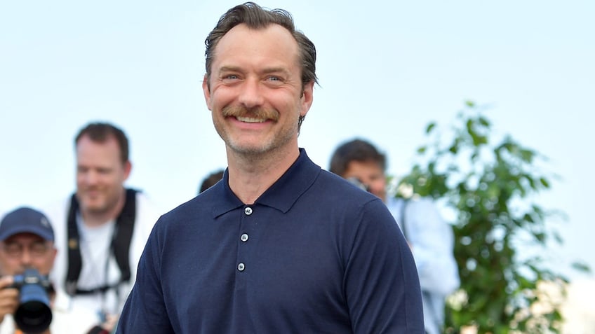 Jude Law in a navy shirt at the Cannes Film Festival