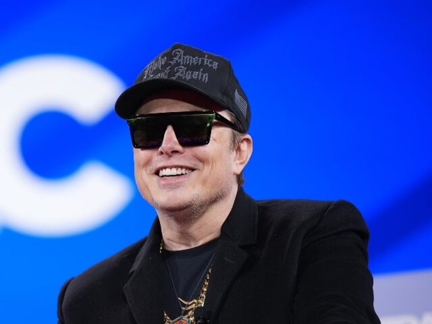 Elon Musk smiles like a gangster