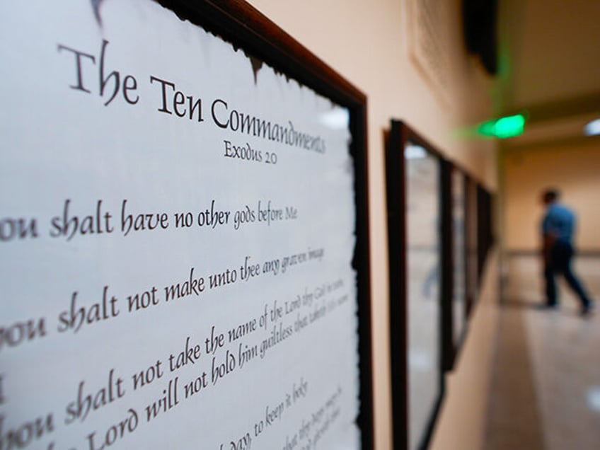 A copy of the Ten Commandments is posted along with other historical documents in a hallwa