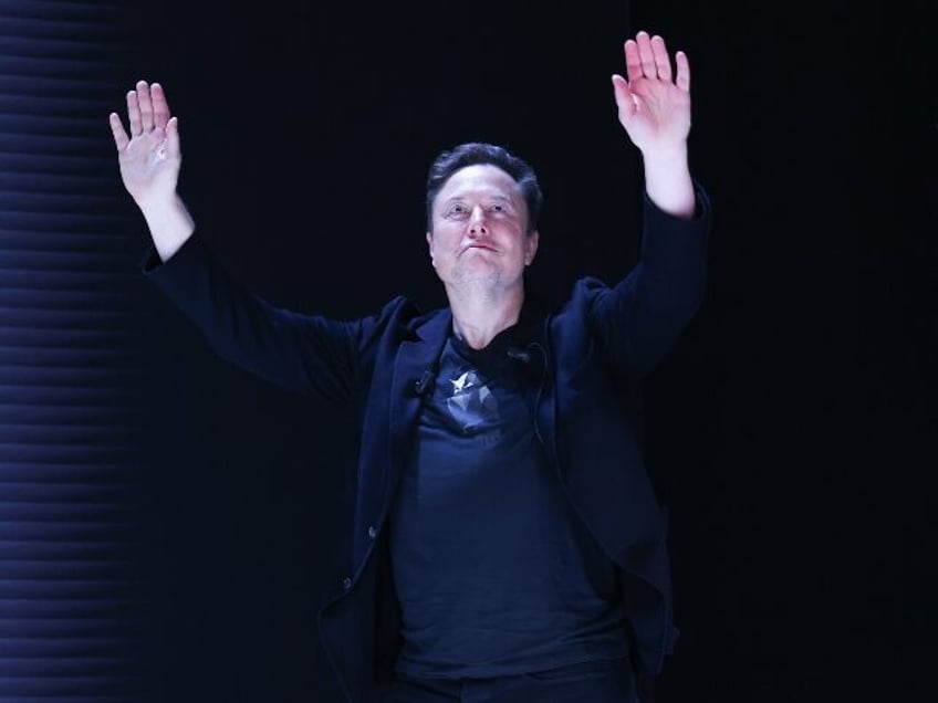 Elon Musk with hands up