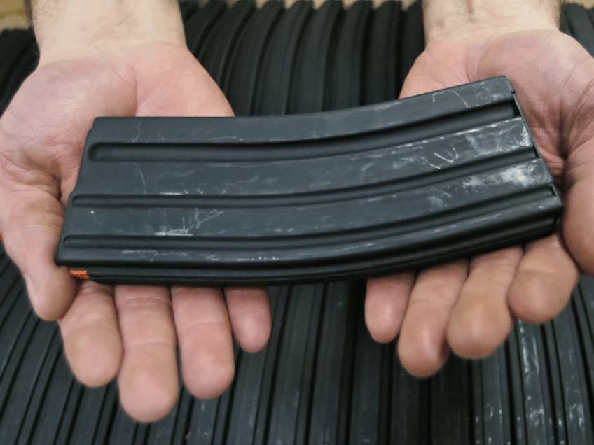 Jonathan Scalise, owner of Ammunition Storage Components, holds a 30 round magazine that h