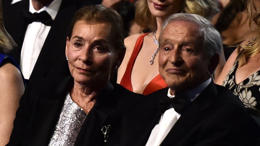 Judy Sheindlin and Jerry Sheindlin sitting in the audience of an event