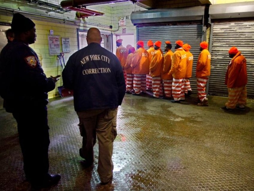 FILE - Inmates file out of the prison bakery at the Rikers Island jail after working the m