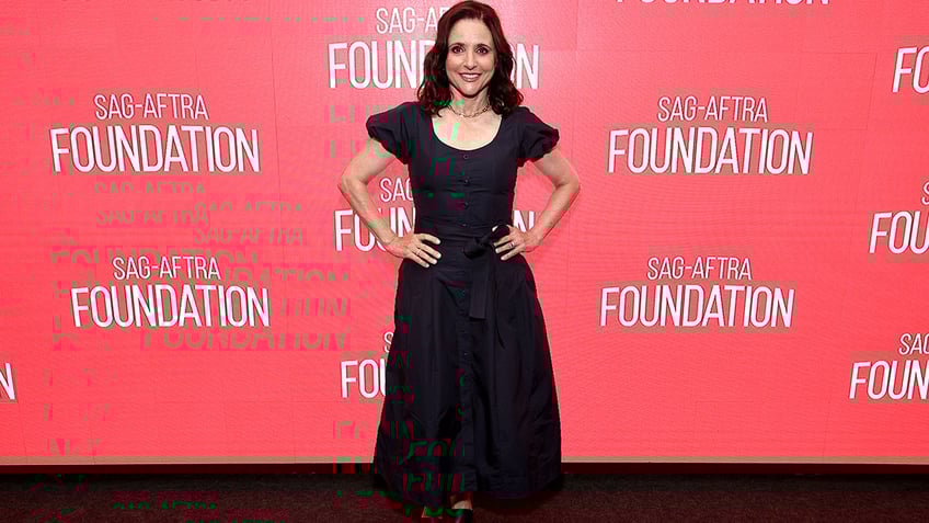 Julia Louis-Dreyfus posed for photos on the red carpet at the SAG-AFTRA Foundation Conversations for her movie "Tuesday," in a button-up black dress with puffed sleeves and a synched waist.
