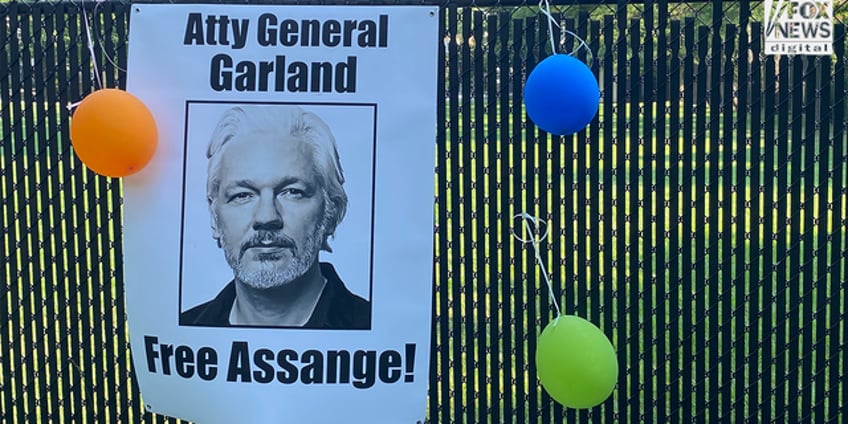 julian assange supporters demand charges be dropped in vigil outside merrick garlands home