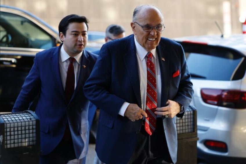 Former New York mayor Rudy Giuliani arrives in court for his civil trial for defaming two Georgia election workers