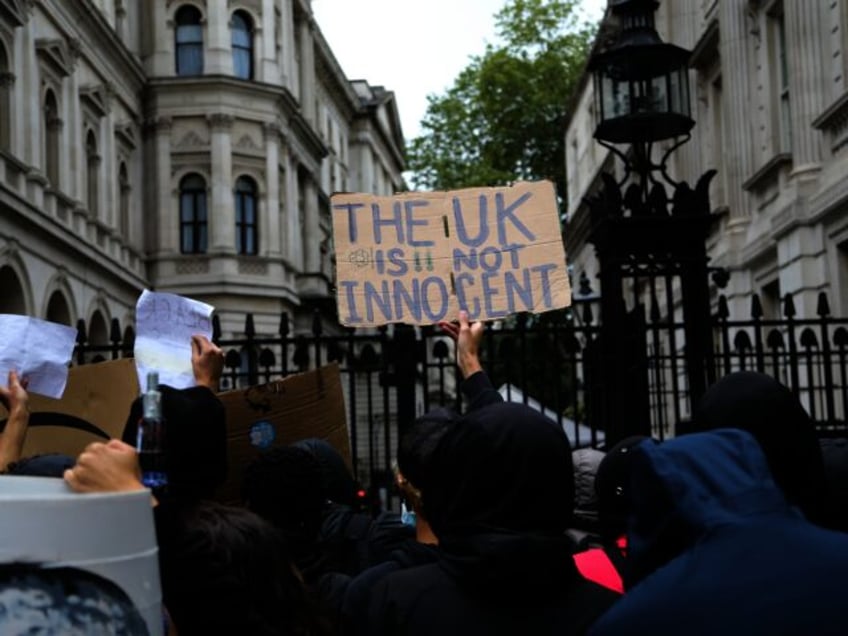 LONDON, UNITED KINGDOM - JUNE 07: A demonstrator holds a banner reading "The UK Is Not Inn