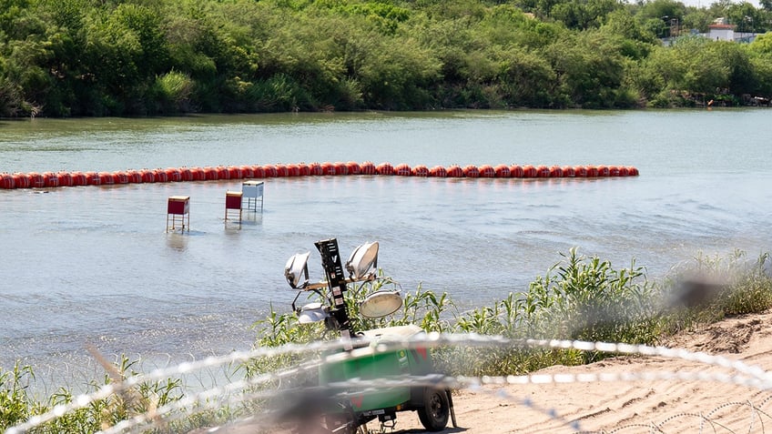 justice department files injunction against texas over floating border barrier in rio grande