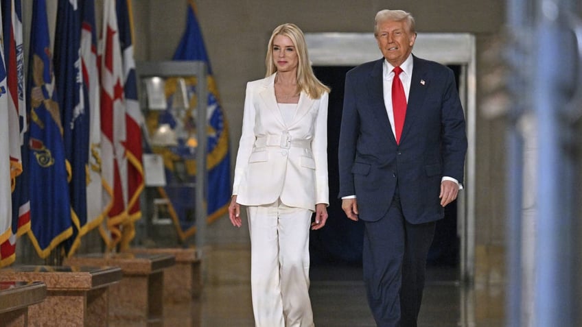 President Donald Trump arrives with Attorney General Pam Bondi to speak at the Justice Department in Washington, D.C., on Friday, March 14, 2025.