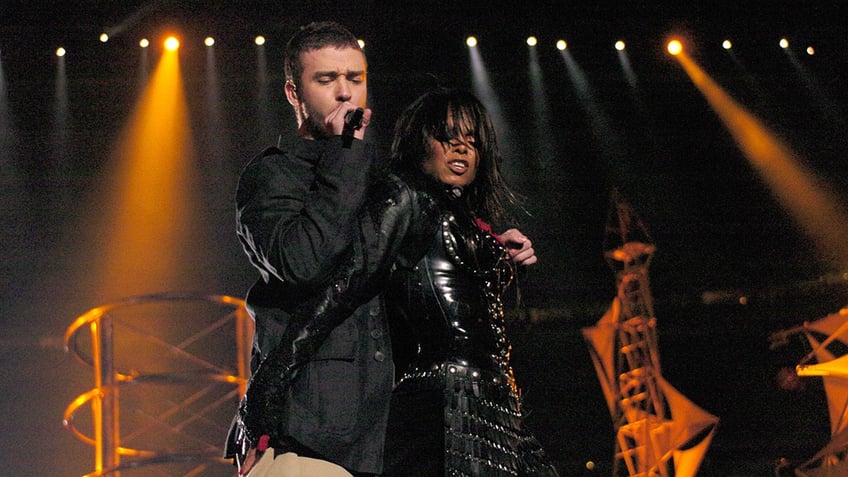 Justin Timberlake in a black jacket performs with Janet Jackson, wearing black latex, during the Super Bowl halftime show in 2004